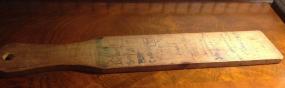school spanking paddle with spanked children's
                  names written on it